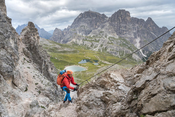 Sesto / Sexten, province of Bolzano, Dolomites, South Tyrol, Italy. Climber on the via ferrata 