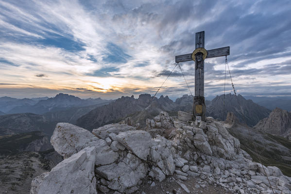 Sesto / Sexten, province of Bolzano, Dolomites, South Tyrol, Italy. The summit cross at the Mount Paterno in the sunset
