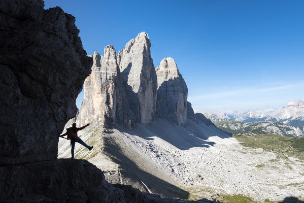 Sesto / Sexten, province of Bolzano, Dolomites, South Tyrol, Italy. Silhouette of a mountaineer in front of the Three Peaks of Lavaredo