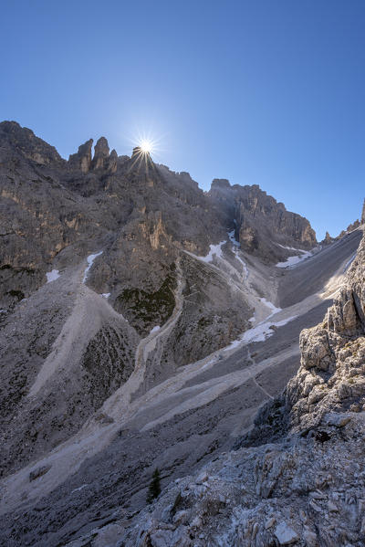 Misurina, Cadini mountains, Dolomites, province of Belluno, Veneto, Italy. The sun rises behind Torre del Diavolo