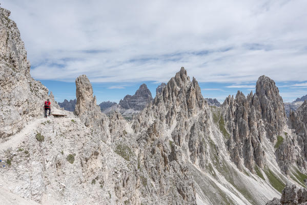 Misurina, Cadini mountains, Dolomites, province of Belluno, Veneto, Italy. A mountaineer on the mountain trail 