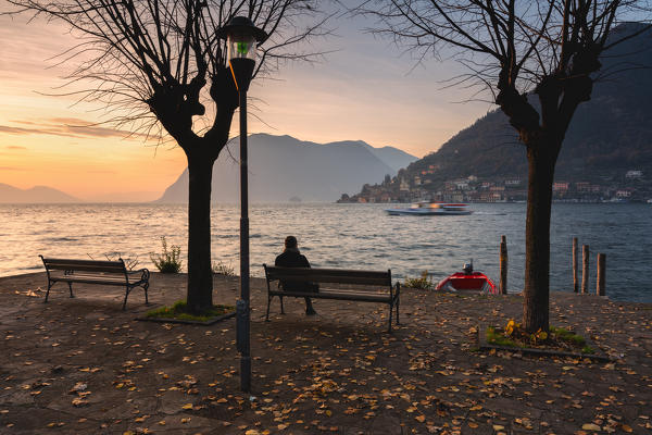Girl at sunset on Lake Iseo, Brescia province, Lombardy district, Italy, Europe.