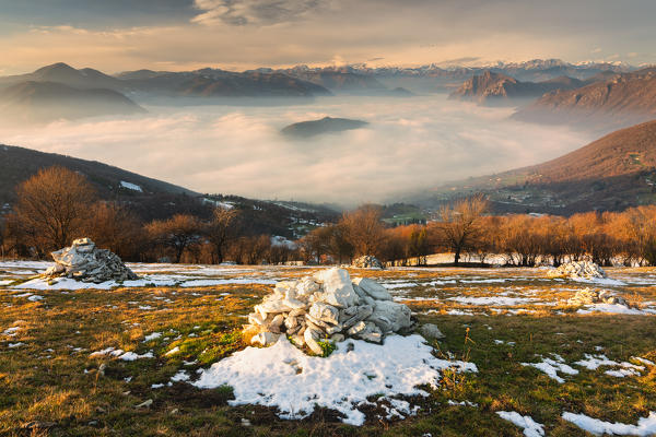 Iseo lake under the fog in Autumn season at sunset, Lombardy district, Brescia province, Italy, Europe