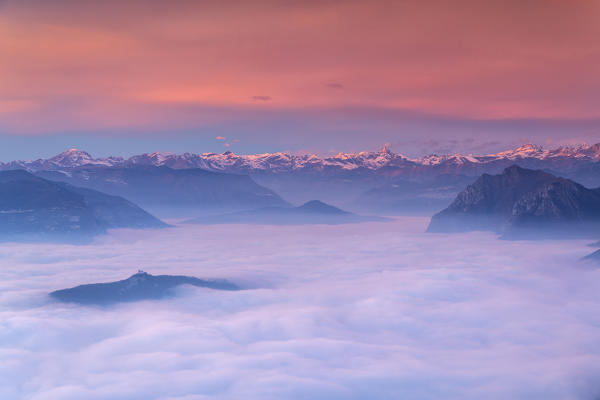 Iseo lake under the fog in Autumn season at sunset, Lombardy district, Brescia province, Italy, Europe