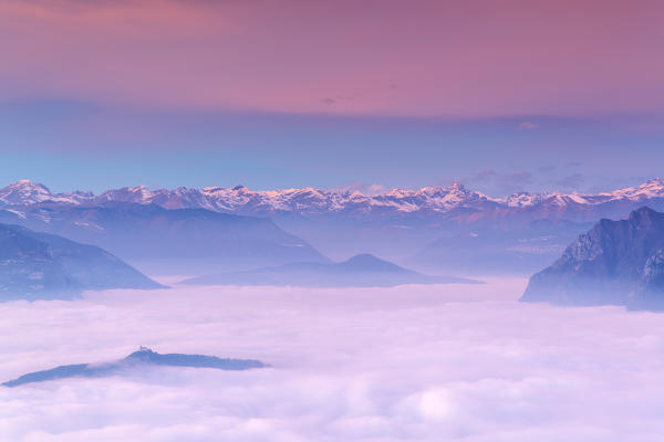 Iseo lake under the fog in Autumn season at sunset, Lombardy district, Brescia province, Italy, Europe