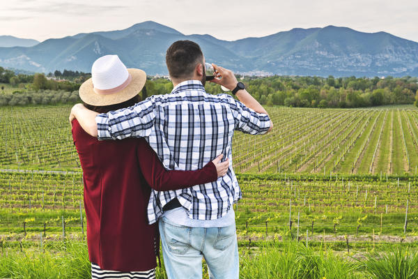 Couple among the vineyards of Franciacorta, Brescia province, Lombardy district, Italy, Europe