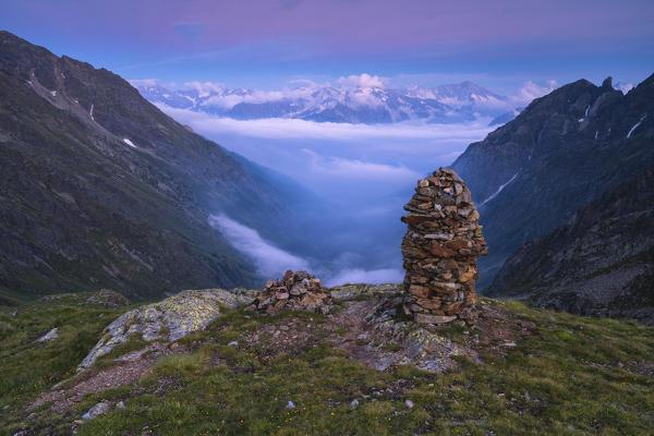 Sunset over the fog in Canè valley, Vallecamonica, Brescia province, Italy.