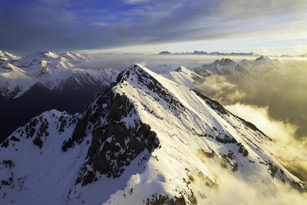Landscape of Italian Alps in Winter season, Aerial view from Pizzo Camino group during a sunrise, Brescia province, Vallecamonica in Italy, Europe.
