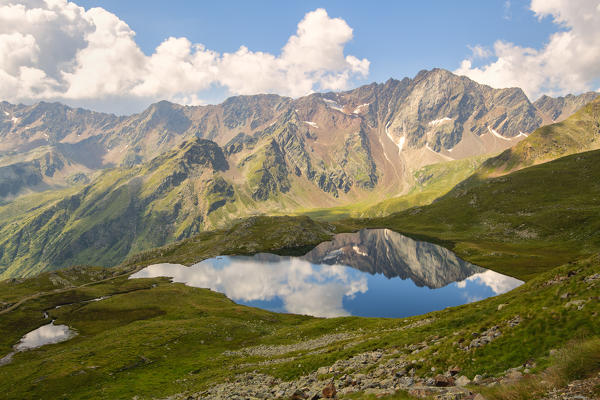 Pietrarossa reflected in the black lake, Gavia pass, Lombardy district, Italy, brescia province.