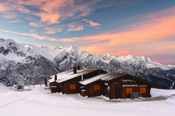 Nigritella refuge in Winter season at dawn, Stelvio national park in Camonica valley, Lombardy district, Brescia province, Italy.