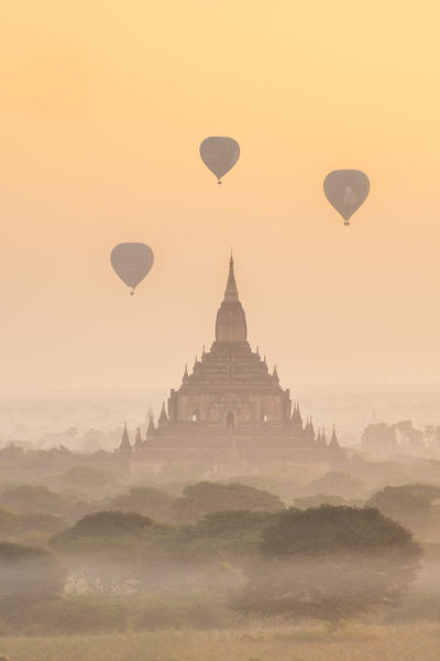 Bagan, Mandalay region, Myanmar (Burma). Sulamani temple at sunrise with baloons in the sky.