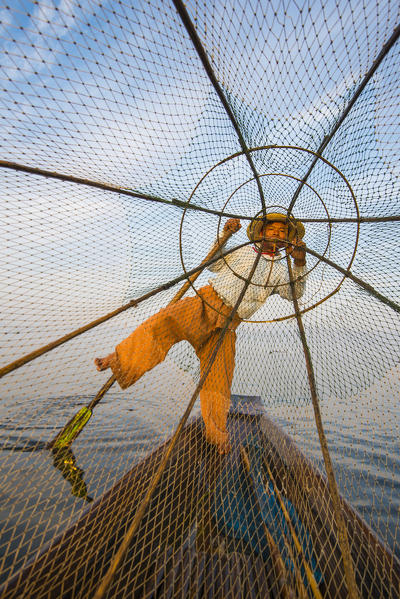 Inle lake,  Nyaungshwe, Shan state, Myanmar. Fisherman looking through the fishing net.