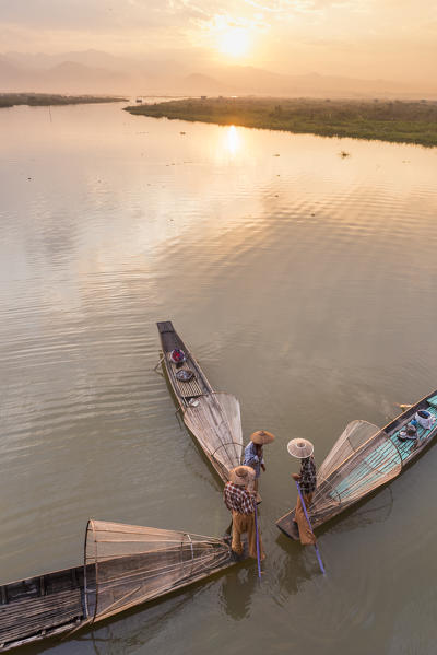 Inle lake, Nyaungshwe township, Taunggyi district, Myanmar (Burma). Thee local fishermen with the conic nets on the boats seen from above.