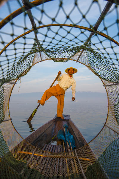 Inle lake, Nyaungshwe township, Taunggyi district, Myanmar (Burma). Local fisherman through the typical conic fishing net.