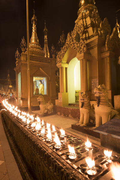 Yangon, Myanmar (Burma). Rows of candles in the Shwedagon pagoda at night.