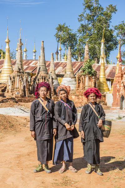 Indein, Inlay Lake, Shan State, Myanmar. Women posing among the stupas of the Shwe Indein Pagodas.