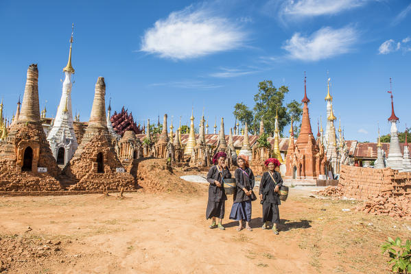 Indein, Inlay Lake, Shan State, Myanmar. Women posing among the stupas of the Shwe Indein Pagodas.