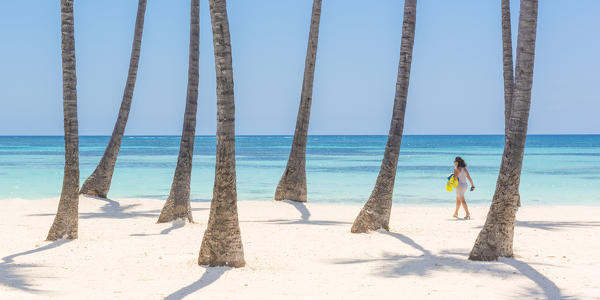 Juanillo Beach (playa Juanillo), Punta Cana, Dominican Republic. Woman walking on the palm-fringed beach (MR).