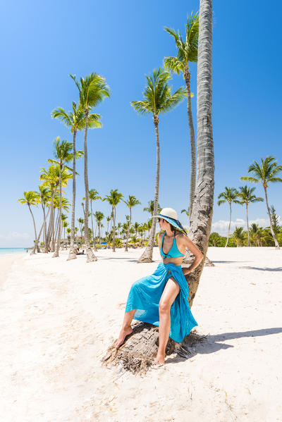 Juanillo Beach (playa Juanillo), Punta Cana, Dominican Republic. Woman relaxing on a palm-fringed beach (MR).