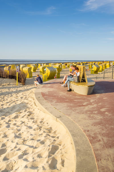 Duhnen, Cuxhaven, Lower Saxony, Germany. People on the seafront and Strandkorbs on the beach