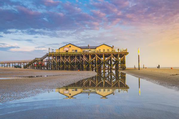 Sankt Peter-Ording, Eiderstedt, North Frisia, Schleswig-Holstein, Germany. Stilt house on the Wadden sea with low tide.