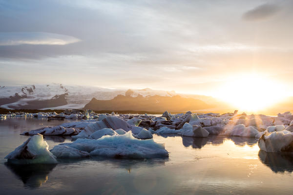 Iceland, Jokulsarlon Glacier Lagoon, icebergs and ice chunk at sunset