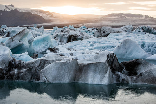 Iceland, Jokulsarlon Glacier Lagoon, icebergs and ice chunk at sunset