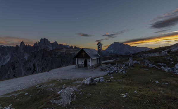 Tre Cime di Lavaredo, Three peaks of lavaredo, Drei Zinnen, Dolomites, Veneto, South Tyrol, Italy. Church near Tre Cime di Lavaredo at sunset.