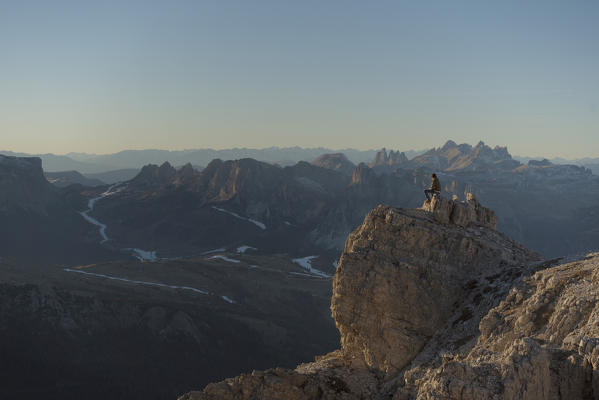 Puez, Odle, Lagazuoi mount, Falzarego Pass, Cortina d'Ampezzo, Dolomiti, Dolomites, Belluno, Veneto, Italy. Hiker looking at panorama from Lagazuoi.