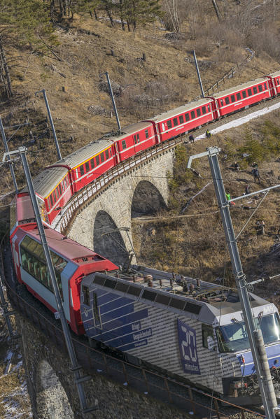 Filisur, Switzerland. The red train running away on the viaduct.