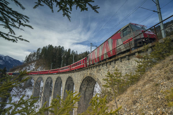 Filisur, Switzerland. The red train running away on the viaduct.