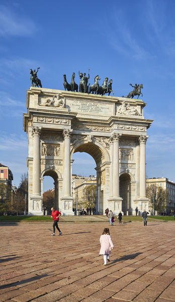 Milan, Lombardy, Italy. A child run at the Arch of The Peace's square.