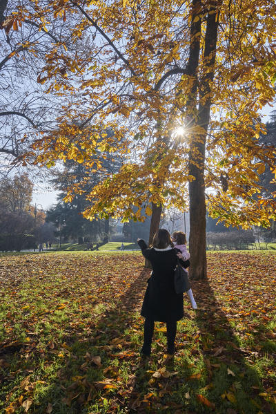 Milan, Lomabrdy, Italy. Woman and daughter at the Sempione Park near Forzesco Castle.