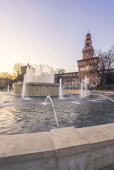 Milan, Lombardy, Italy. The Castello Sforzesco with fountain at sunset
