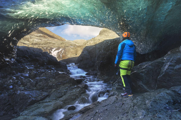 Man inside an ice caver under the Vatnajokull glacier, Vatnajokull national park, East Iceland, Iceland.