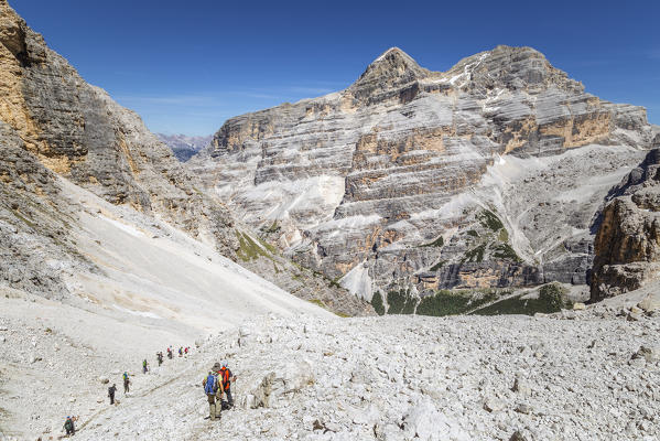 Italy, Veneto, Belluno district, Fanis group, hikers descend towards Val Travenanzes, with the Tofane group in the background