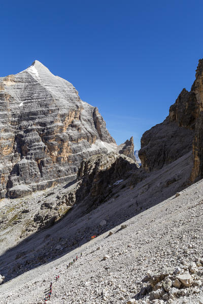 Italy, Veneto, Belluno district, Fanis group, hikers go up the screes towards the Tofana di Rozes