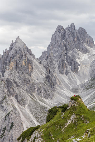 Italy,Veneto,Belluno district,Auronzo di Cadore,a man surrounded by the peaks of Cadini di Misurina