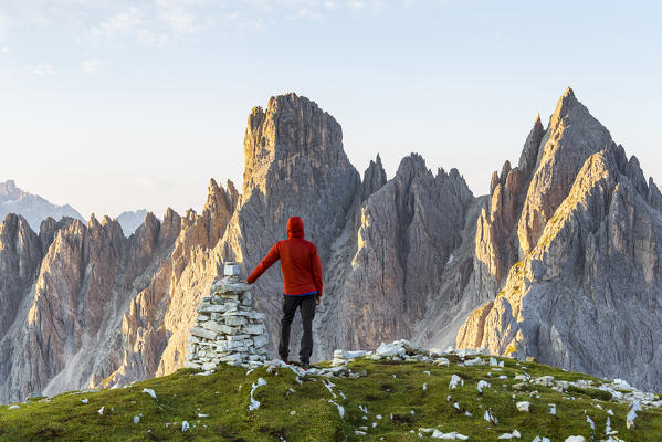 Italy,Veneto,Belluno district,Auronzo di Cadore,a man contemplates the sunrise on the Cadini di Misurina group