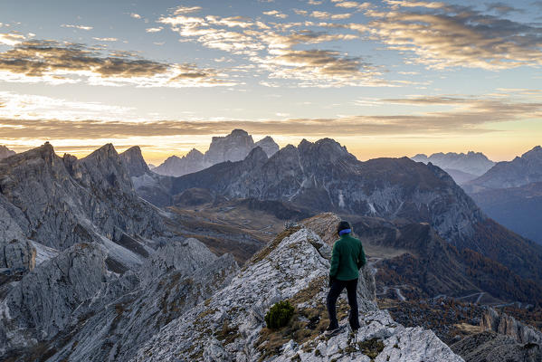 Italy,Veneto,Belluno district,Cortina d'Ampezzo,a man at dawn on top of Mount Croda Negra looks Passo Giau and Monte Pelmo