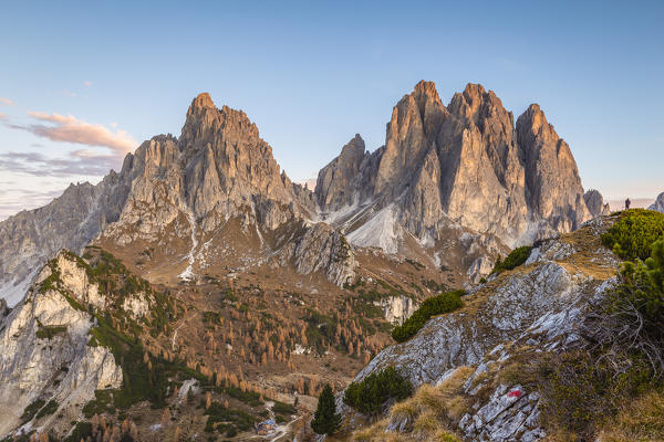 Italy,Veneto,Belluno district,Auronzo di Cadore,a hiker taking photographs of the Cadini di Misurina group at sunrise