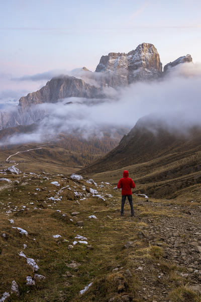 Italy,Veneto,Belluno district,Selva di Cadore,hiker admires Mount Pelmo sticking out of the clouds