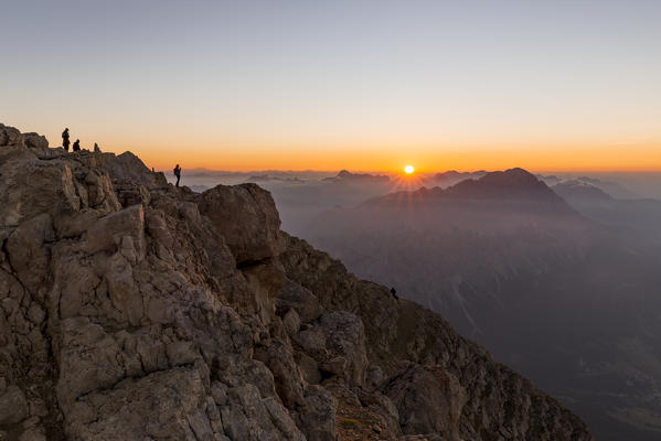 Italy,Veneto,Belluno district,Boite Valley,hikers at the top of Tofana di Mezzo admire the sunrise