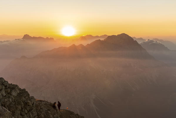 Italy,Veneto,Belluno district,Boite Valley,hikers at the top of Tofana di Mezzo admire the sunrise