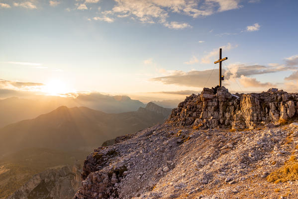 Italy,Veneto,Belluno district,the setting sun lights up the summit cross of Mount Averau