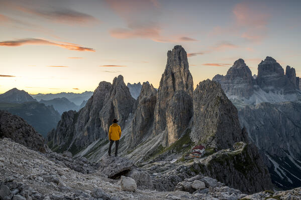 Italy,Veneto,province of Belluno,a hiker enjoys the view over Fonda Savio Hut in the Cadini di Misurina group,with Tre Cime di Lavaredo in the background (MR)
