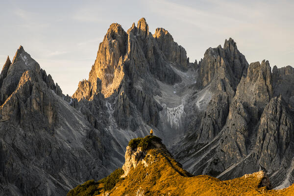 Italy,Veneto,Belluno district,Auronzo di Cadore,hiker surrounded by the peaks of Cadini di Misurina