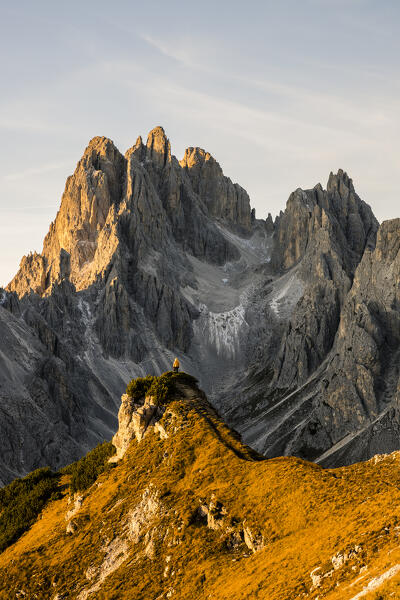 Italy,Veneto,Belluno district,Auronzo di Cadore,hiker surrounded by the peaks of Cadini di Misurina
