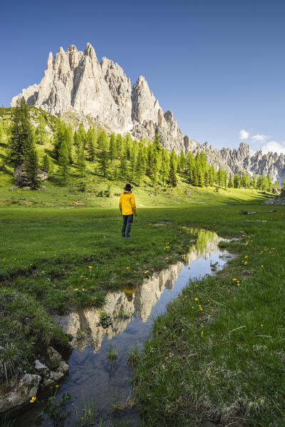 Italy, Veneto, Belluno province, Auronzo di Cadore, hiker admires Cadini di Misurina in the early morning (MR)
