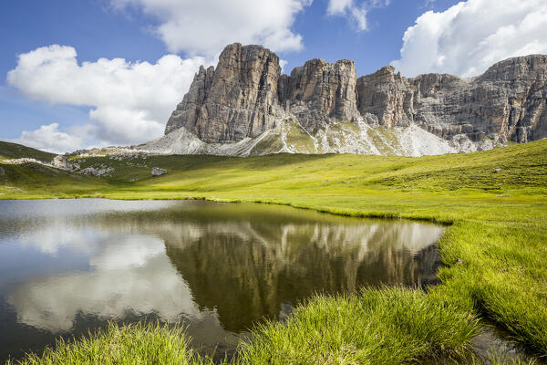 Italy, Veneto, province of Belluno, the Lastoni di Formin reflected in small but very picturesque alpine lake
